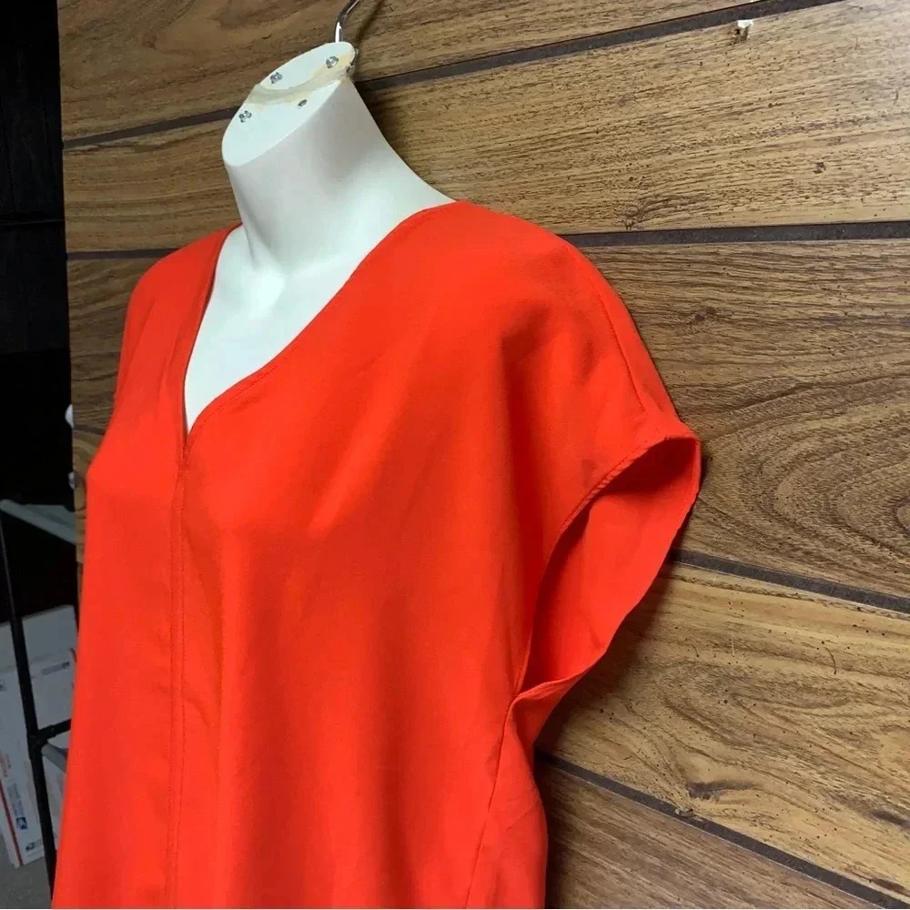 Rachel Zoe bright orange blouse size Small bold seam down the front